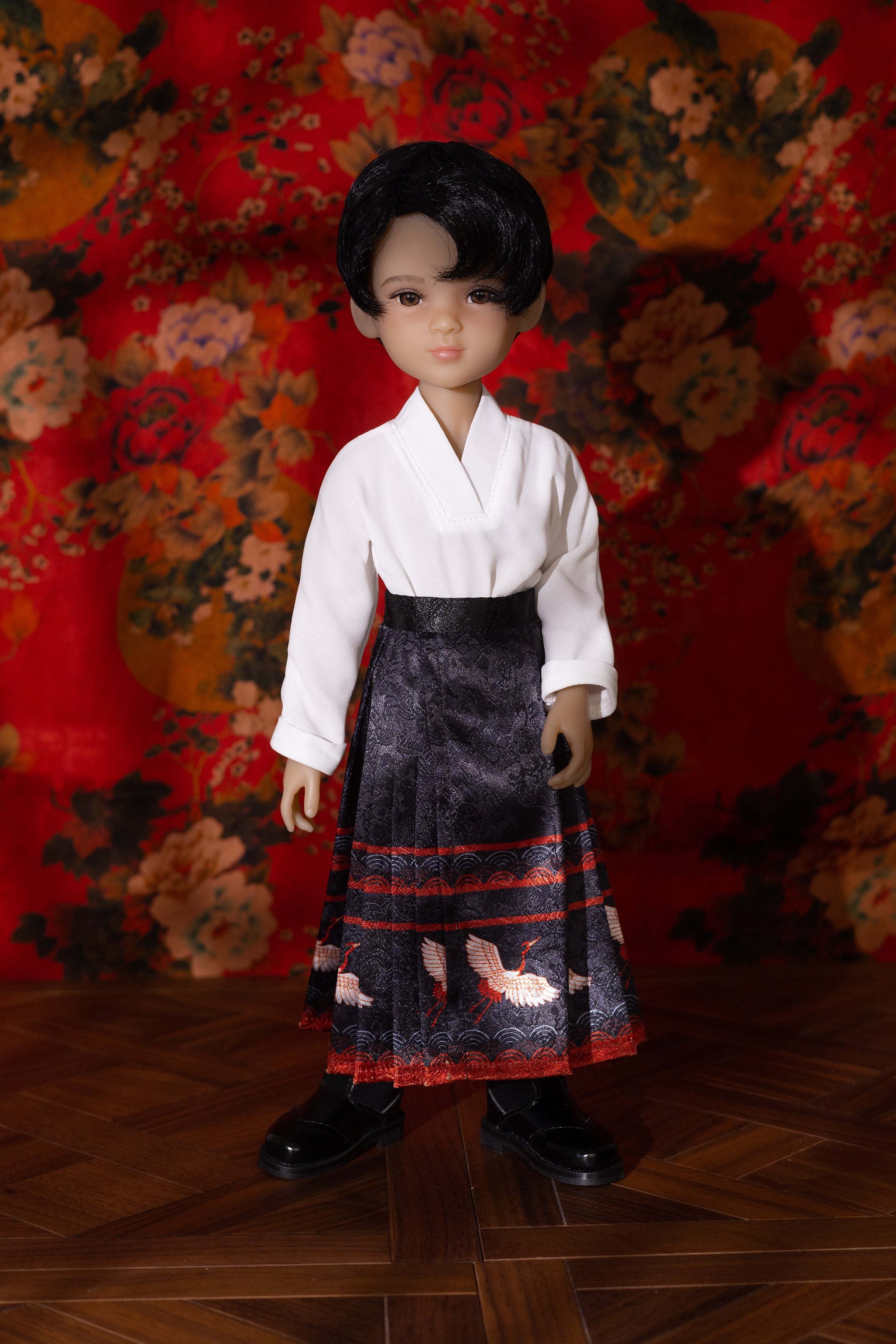Doll wearing a traditional outfit with a floral background