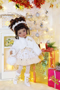 Doll in a festive setting with Christmas tree and presents