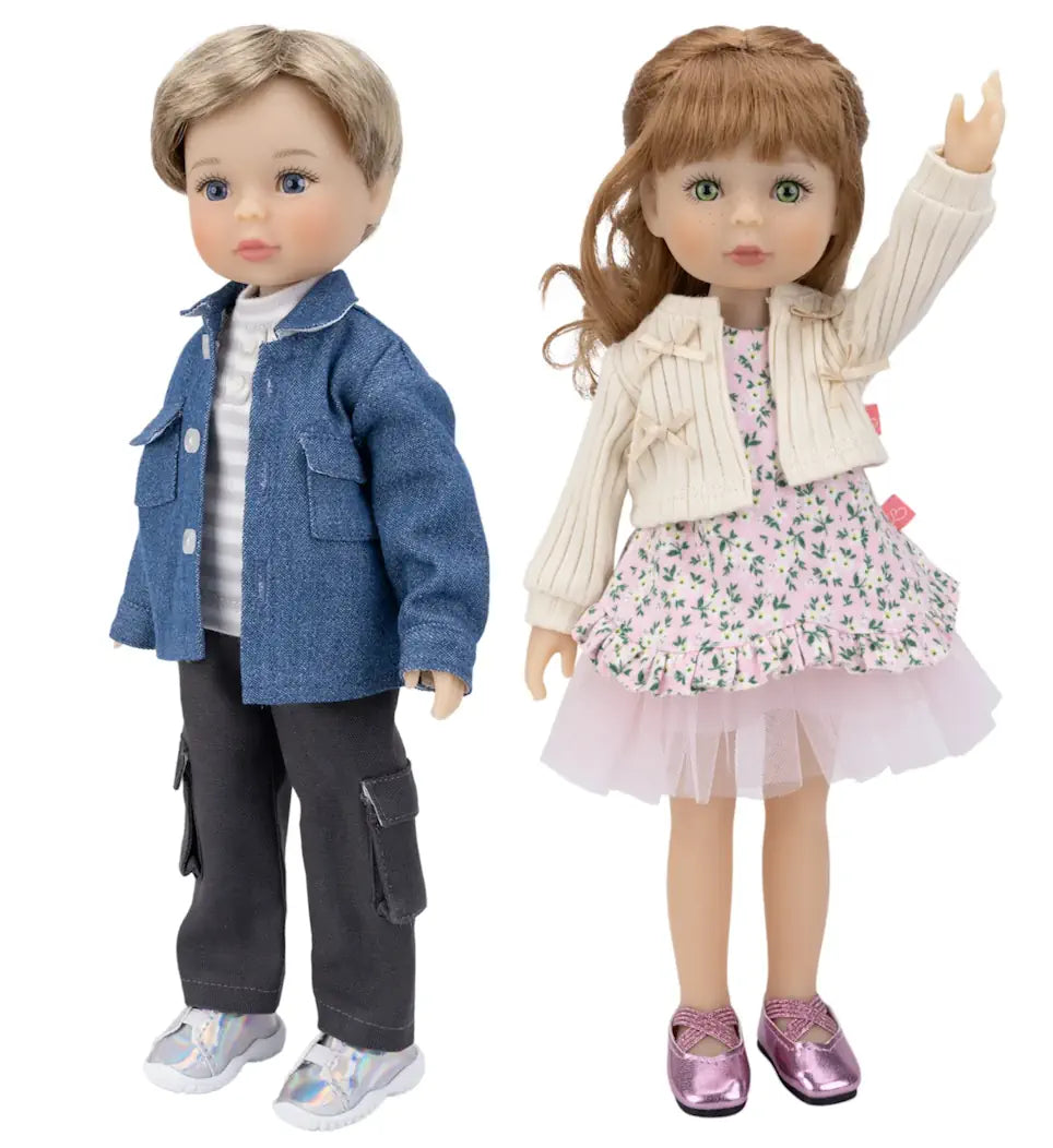 Two dolls, one boy and one girl, standing side by side on a white background.