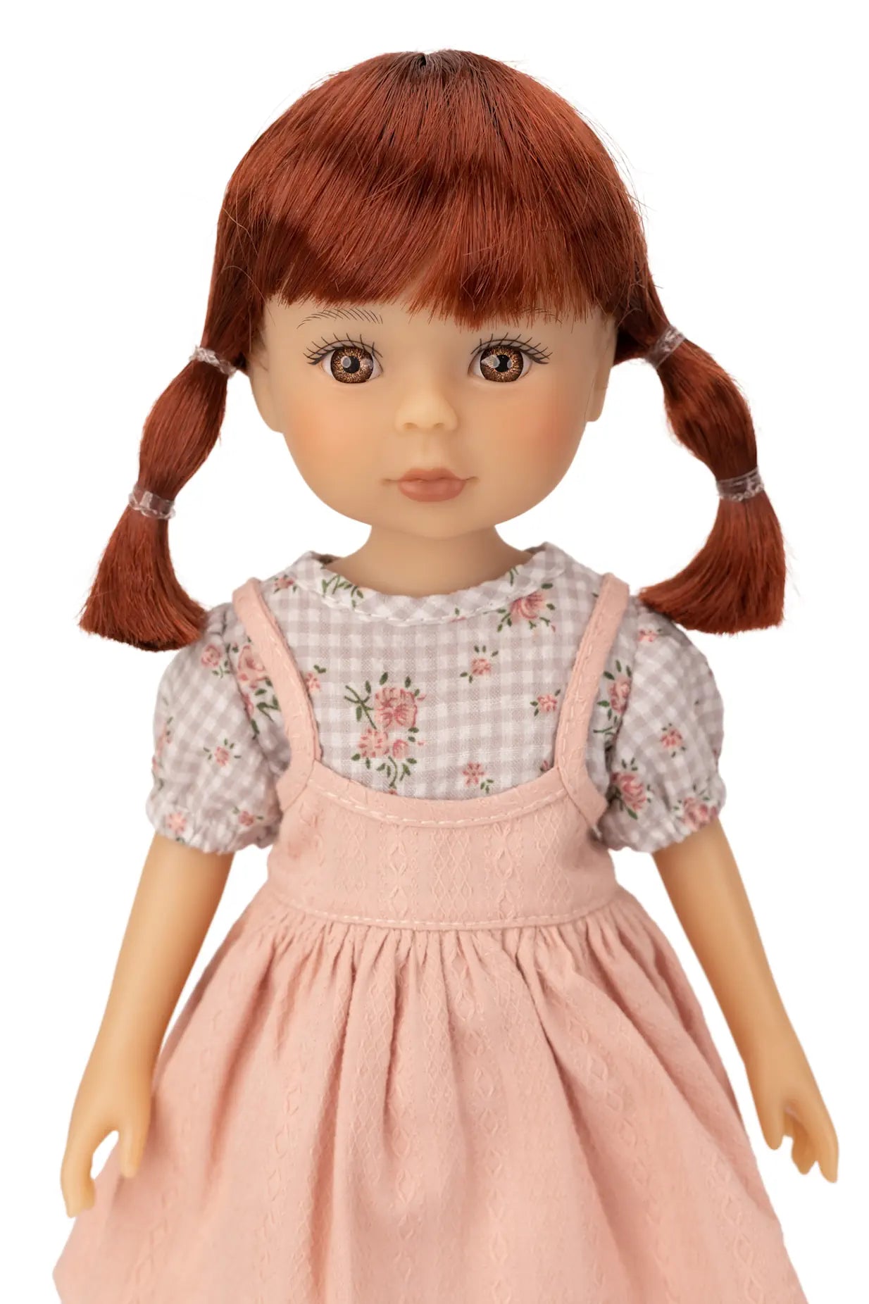 Jolli Buddies Dorothy Doll with red hair in pigtails wearing a checkered shirt and pink dress on a white background