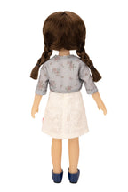 Jolli Buddies Iris Doll wearing a gray floral top and white skirt on a white background