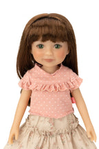 Jolli Buddies Joey Doll wearing a pink polka dot top and floral skirt on a white background