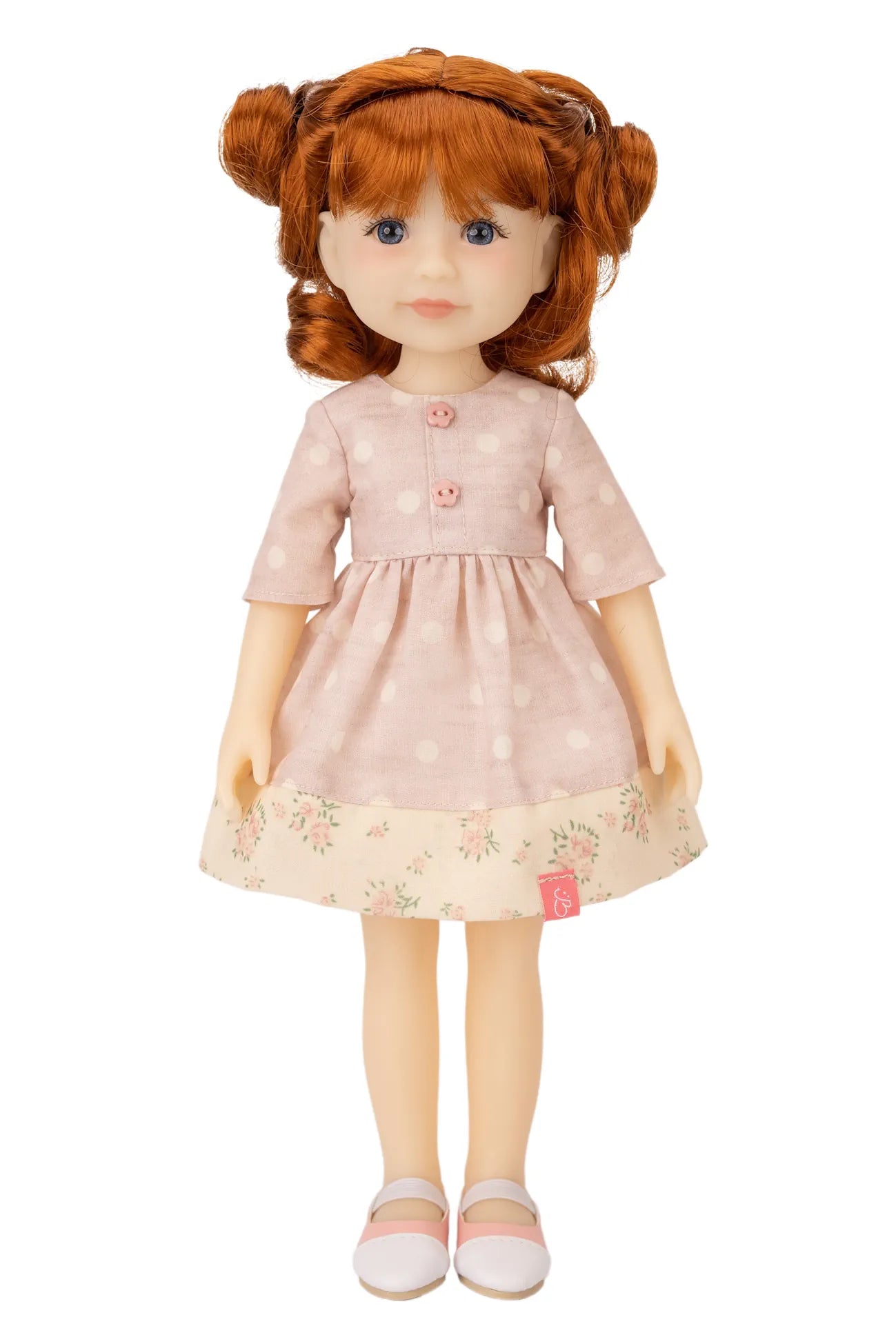 Jolli Buddies Leanne Doll with red hair styled in pigtails, wearing a pink dress with a floral hem, on a white background.