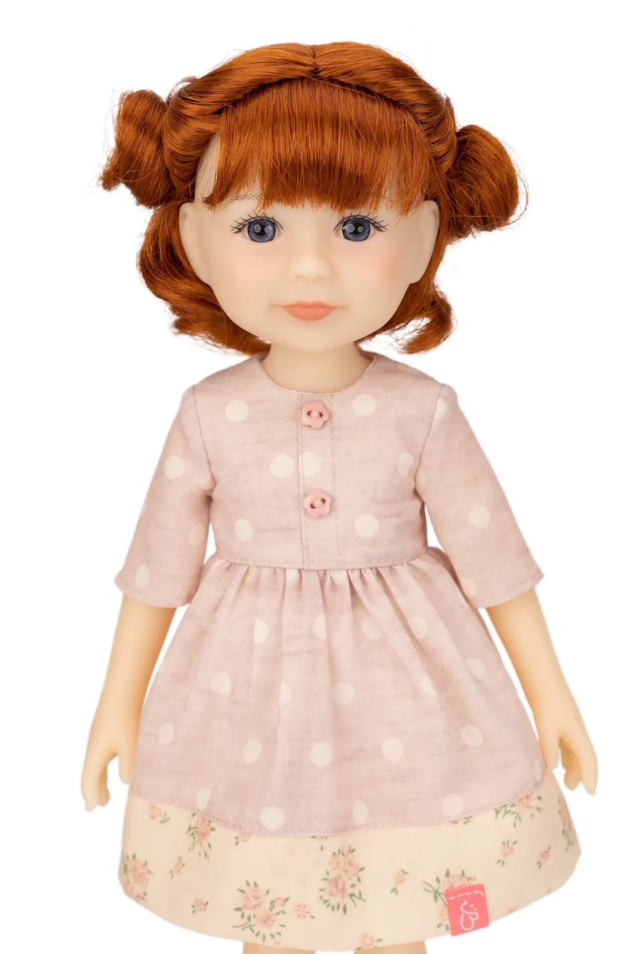 Jolli Buddies Leanne Doll with red hair wearing a pink dress with white polka dots on a white background