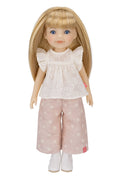 Jolli Buddies Lisa Doll wearing a white blouse with ruffled sleeves and pink polka dot pants on a white background