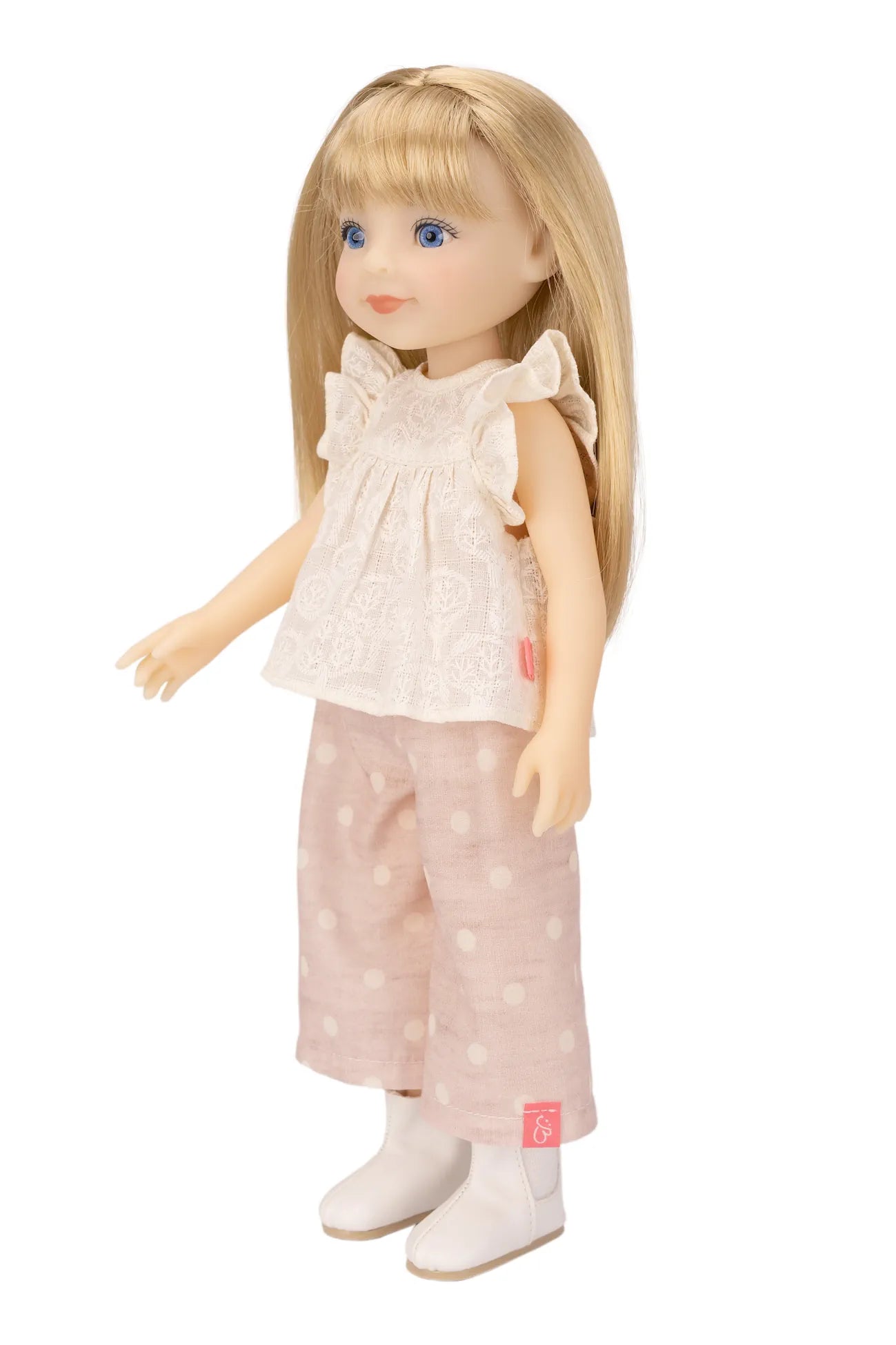Jolli Buddies Lisa Doll wearing a white blouse with ruffles and pink polka dot pants on a white background