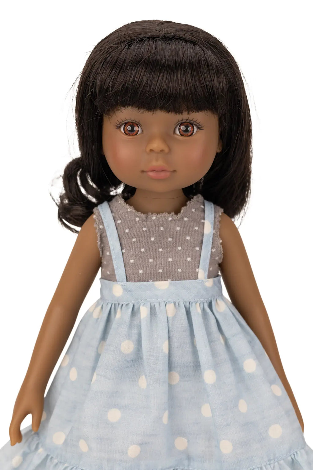Jolli Buddies Ophelia Doll wearing a light blue dress with white polka dots and a grey top with white polka dots.
