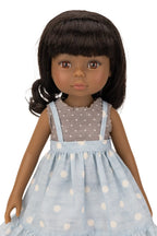 Jolli Buddies Ophelia Doll wearing a light blue dress with white polka dots and a grey top with white polka dots.
