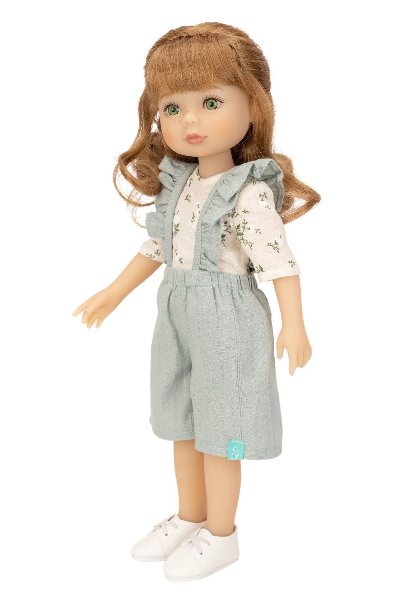 Jolli Buddies Uma Doll wearing a light gray outfit with a vest and shorts on a white background