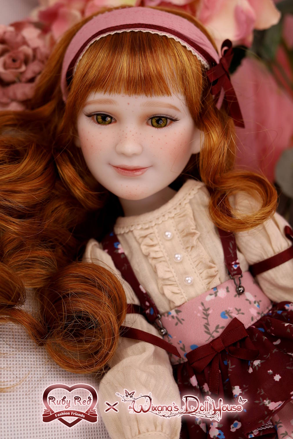 Detailed doll with red hair and a pink headband, wearing a white blouse and maroon dress with floral patterns, surrounded by flowers.