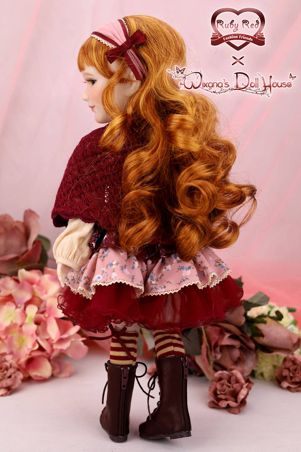 Doll with long red hair and a red outfit standing among flowers, with 'Ruby Red' and 'Wang's Doll House' branding.