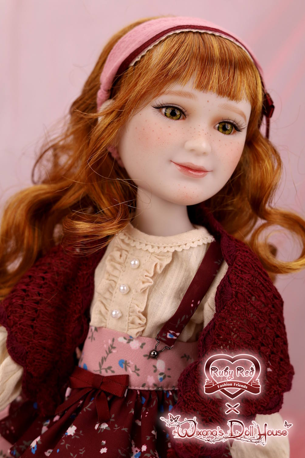 Detailed doll with red hair and a pink headband against a pink background, featuring the Waverly Doll House logo.