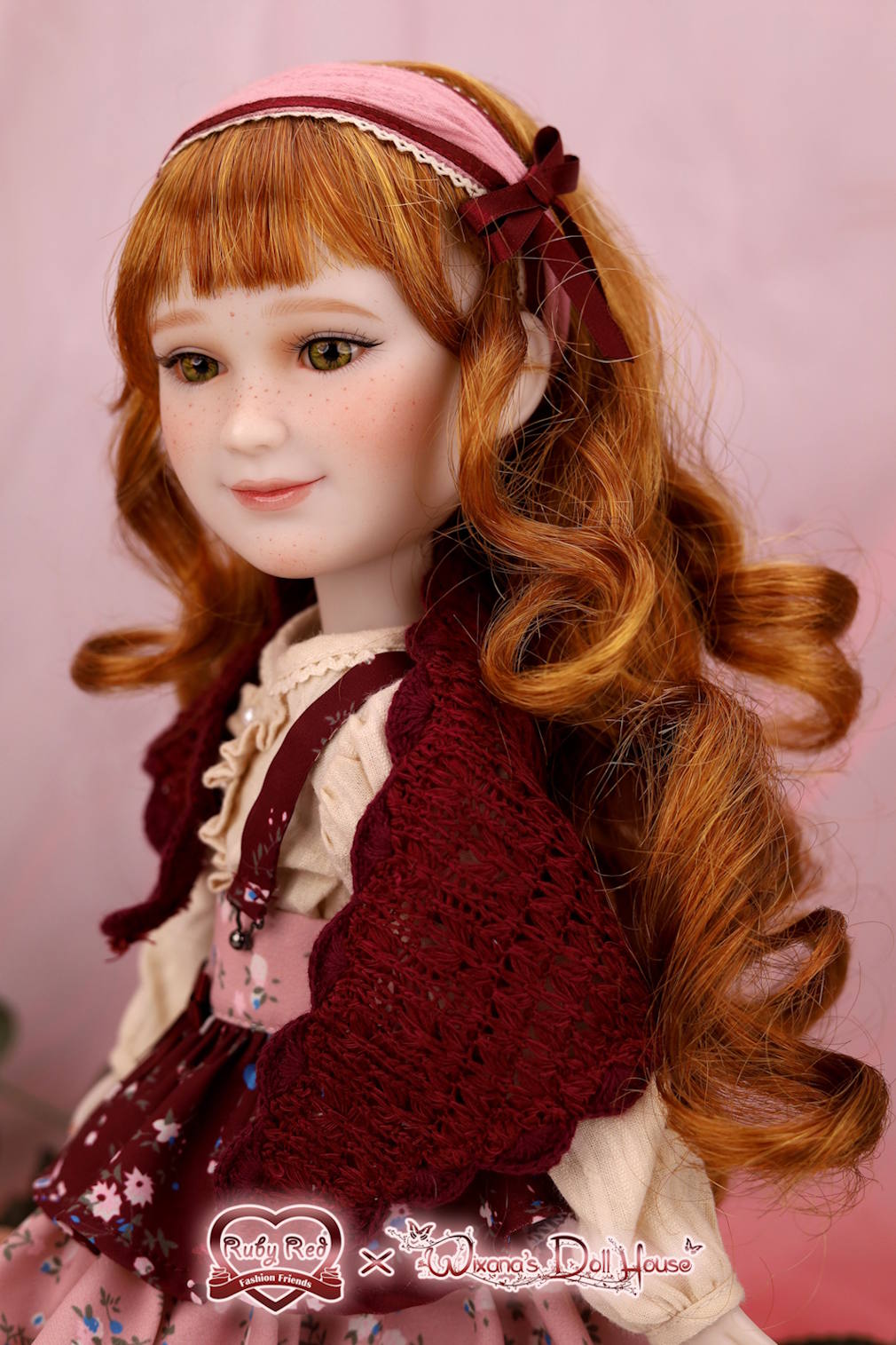 Doll with red hair and vintage outfit against a pink background