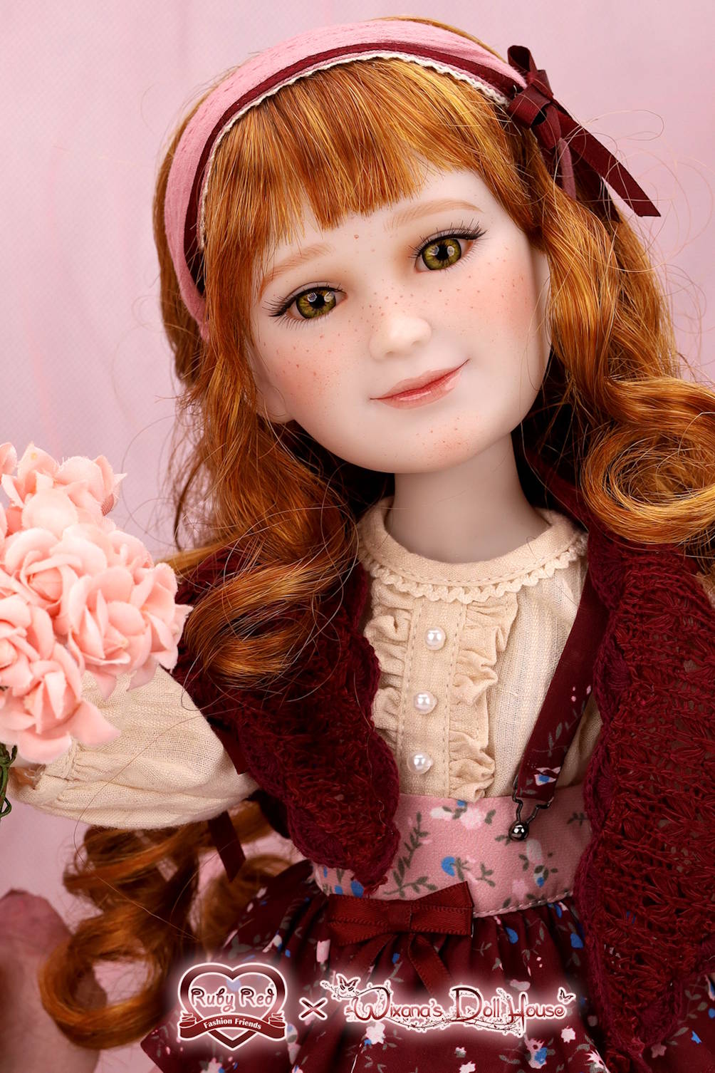 Detailed doll with red hair and a pink headband against a pink background