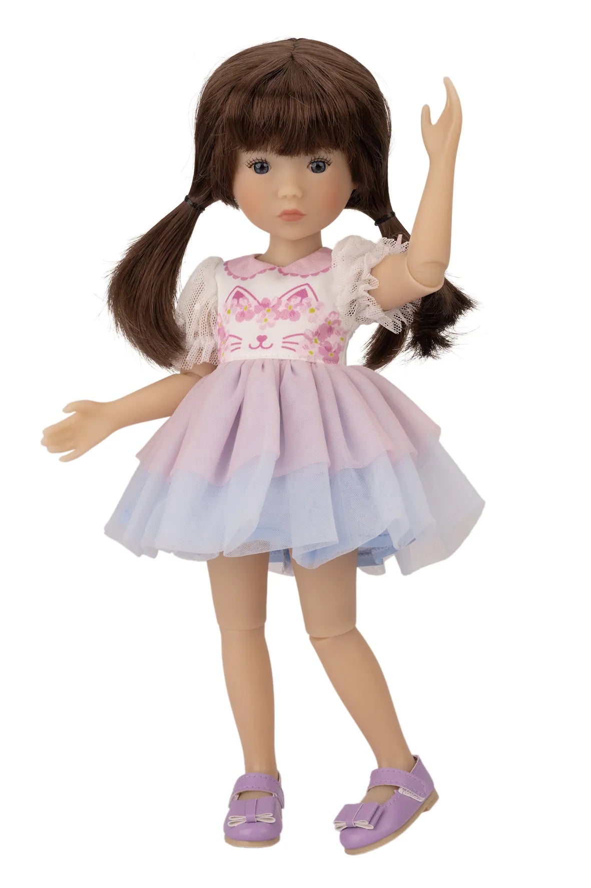 Doll with a pink dress featuring a cat design on a white background