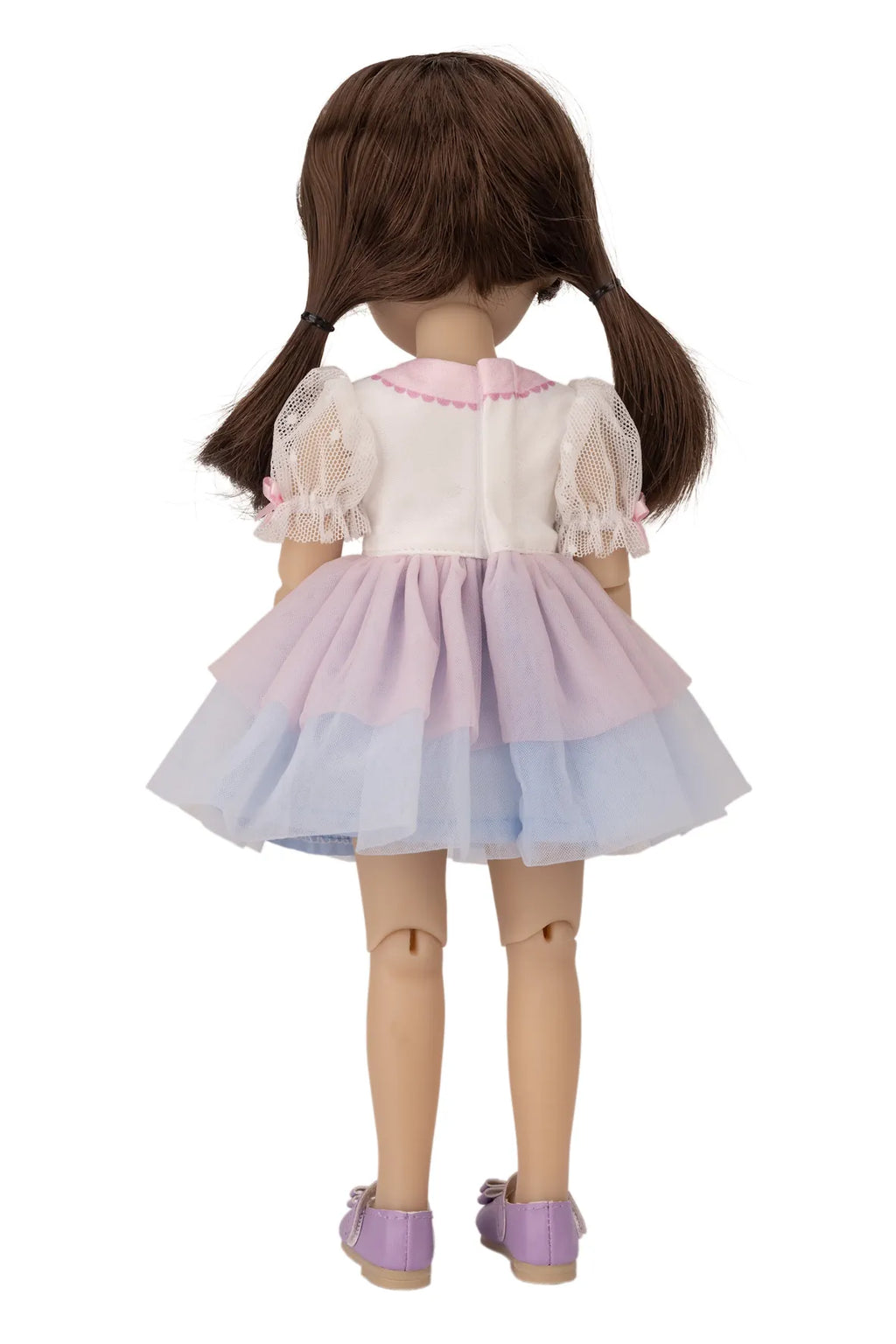 Doll wearing a colorful dress with a white background
