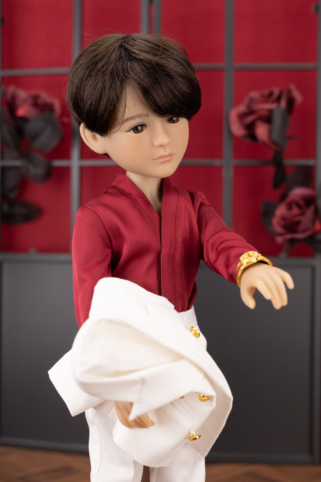 Doll in a red outfit with a white jacket against a red and black checkered background