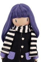 Doll with purple hair and a black and white striped scarf wearing a black coat.
