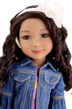 Doll with long brown hair wearing a denim jacket and white headband on a white background