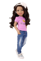 Doll wearing a purple shirt with a bee design and blue jeans on a white background