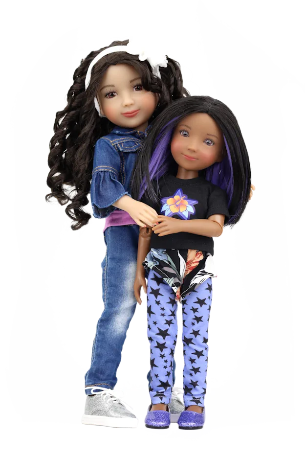 Kayla and Kelsey with long hair, one wearing a denim jacket and jeans, the other in a black top and blue pants with butterfly pattern, on a white background.