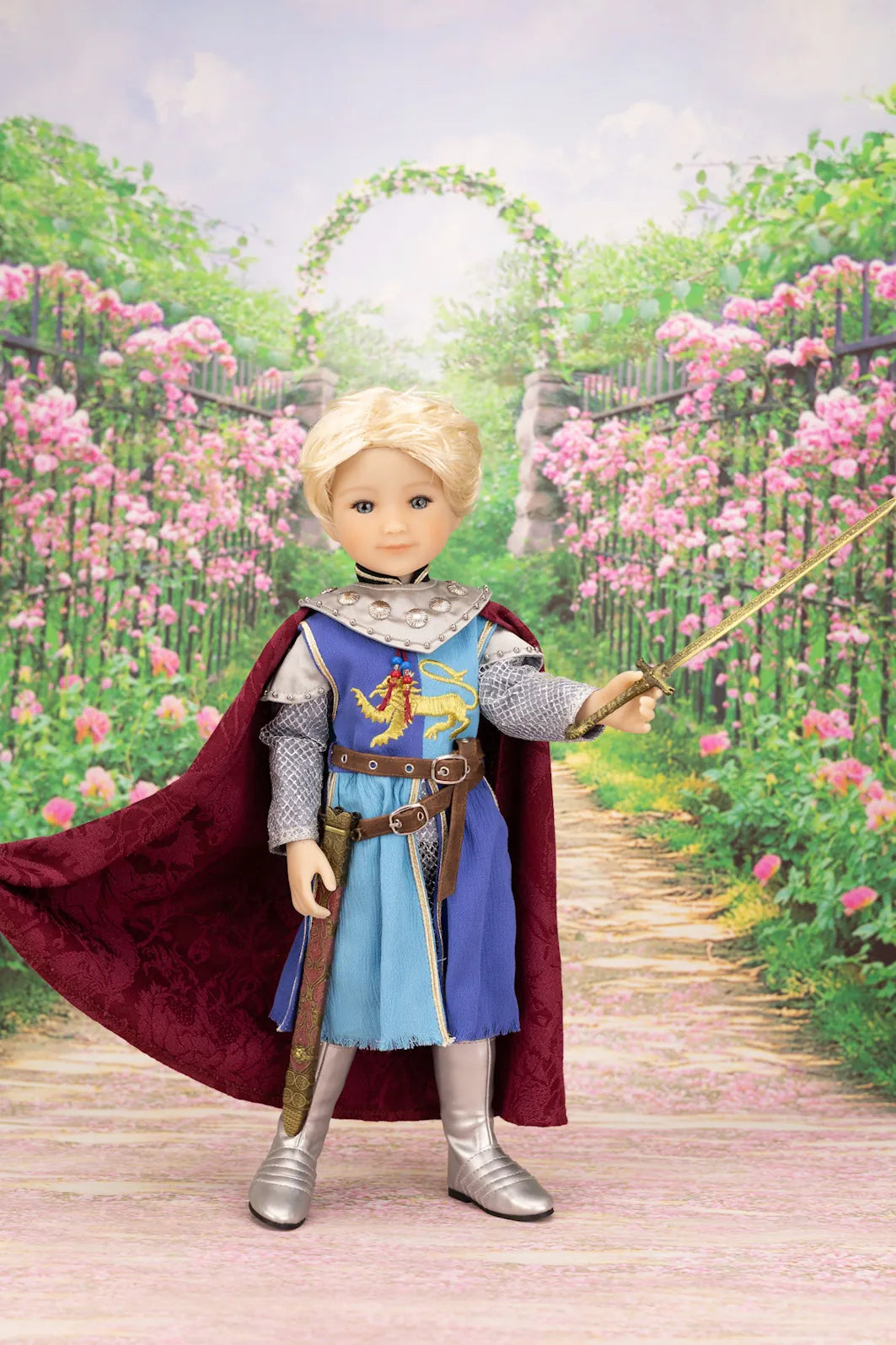 Lancelot doll in medieval costume with cape and sword in garden setting
