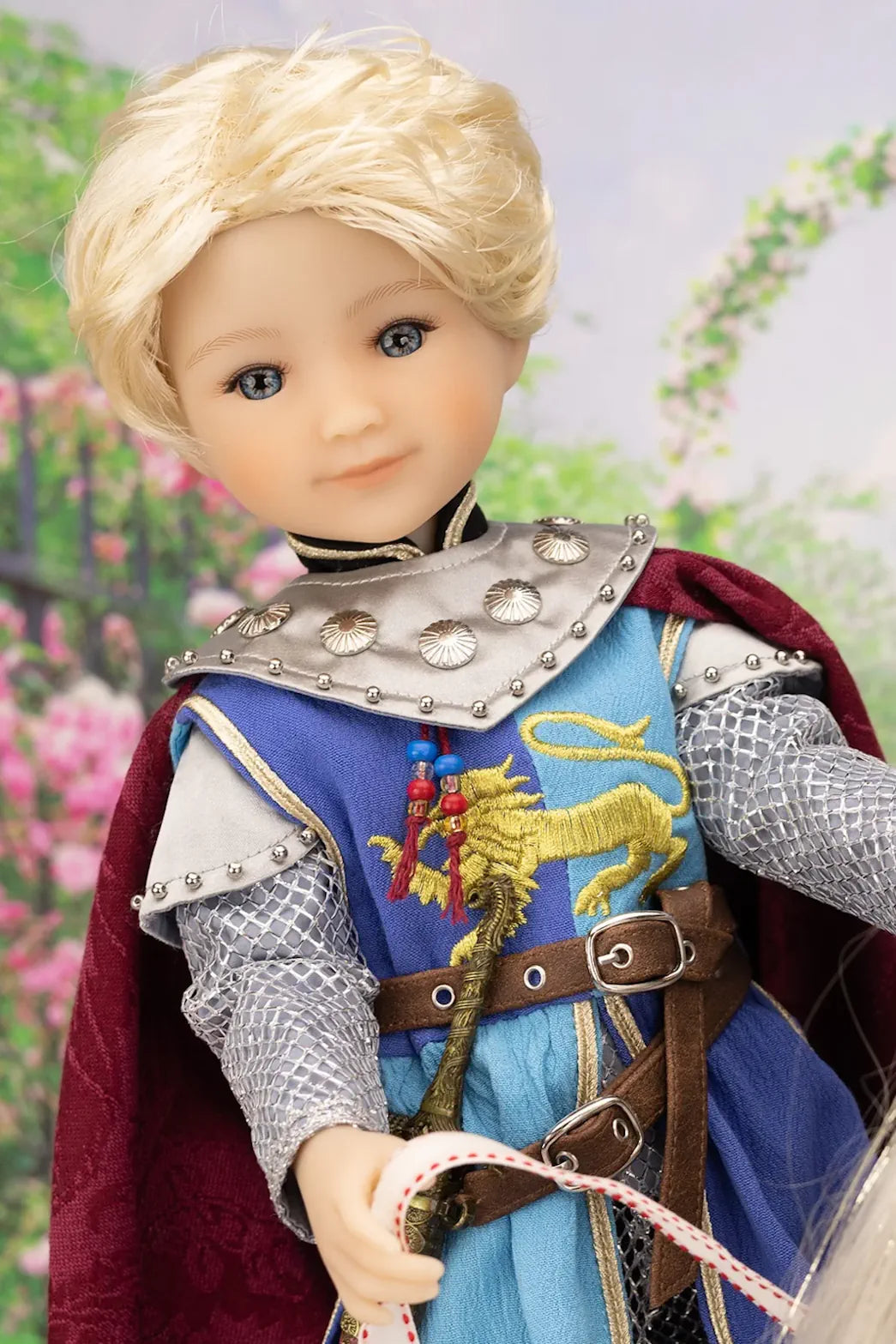 Lancelot doll in medieval costume with armor and cape against a floral background