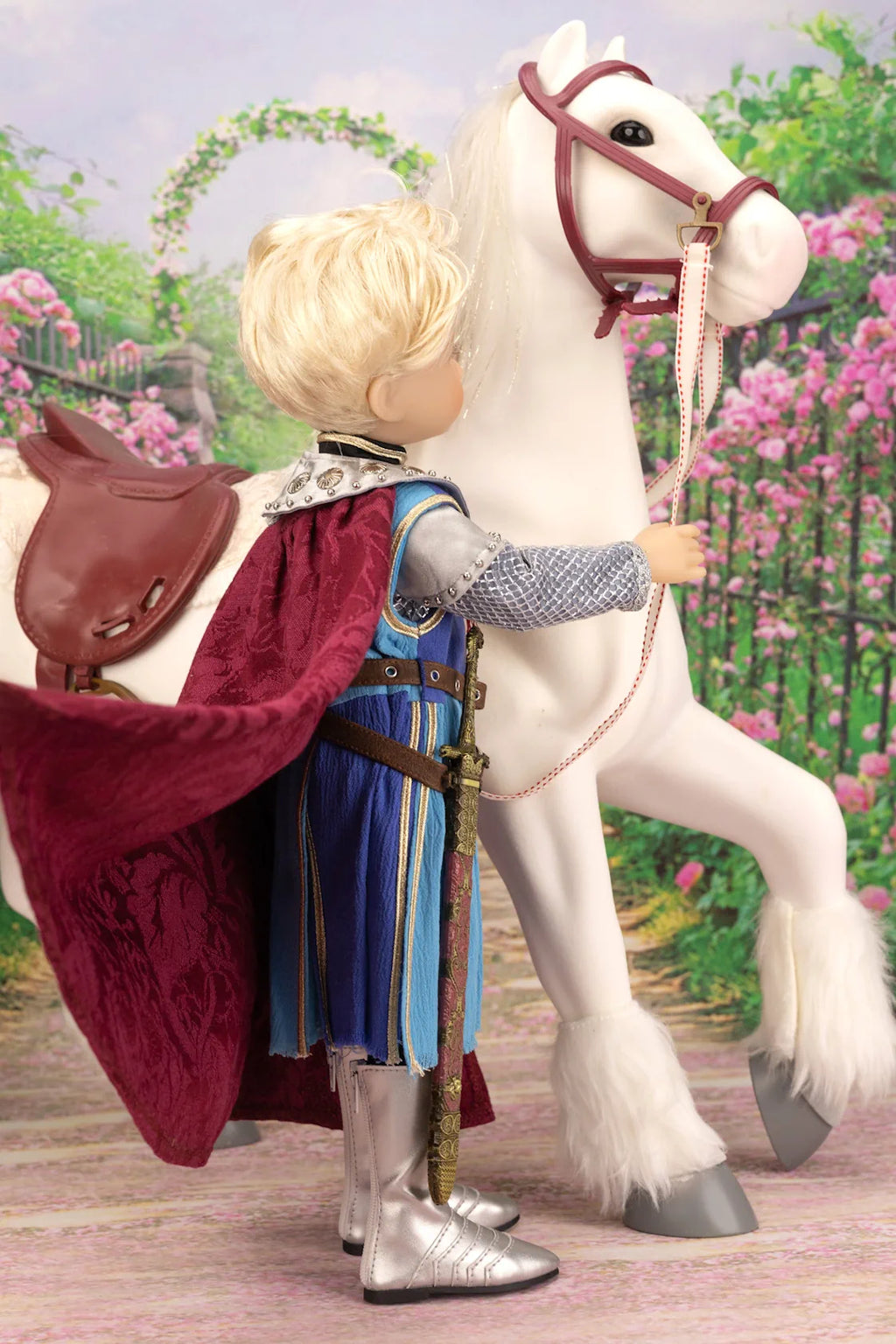 Lancelot doll in knight costume with white horse in garden setting