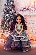 Doll in a festive setting with a decorated Christmas tree and fireplace.