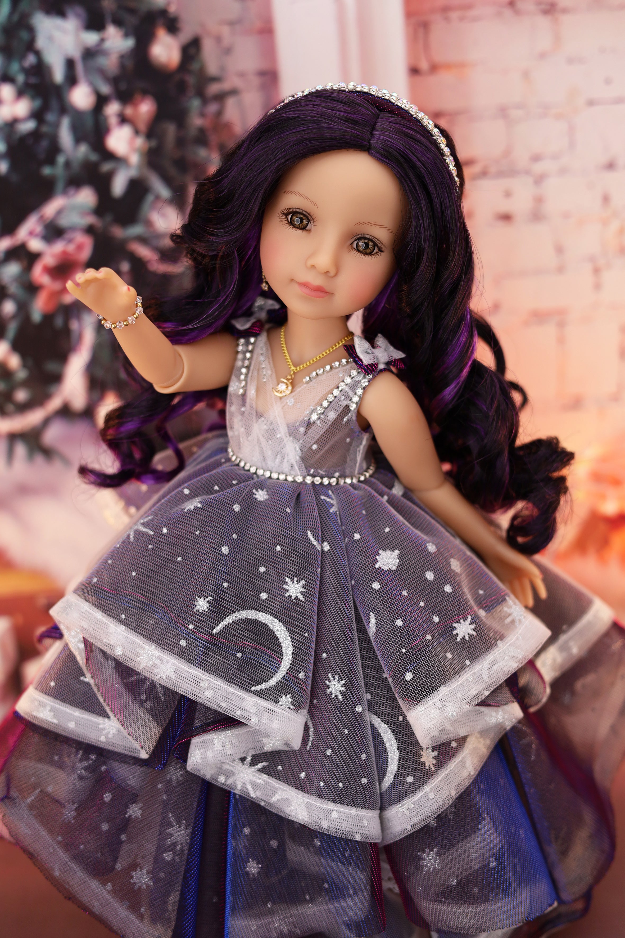Doll with long dark hair wearing a star-patterned dress against a blurred floral background