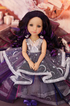 Doll with a gray dress with star patterns and purple hair in a decorative setting.