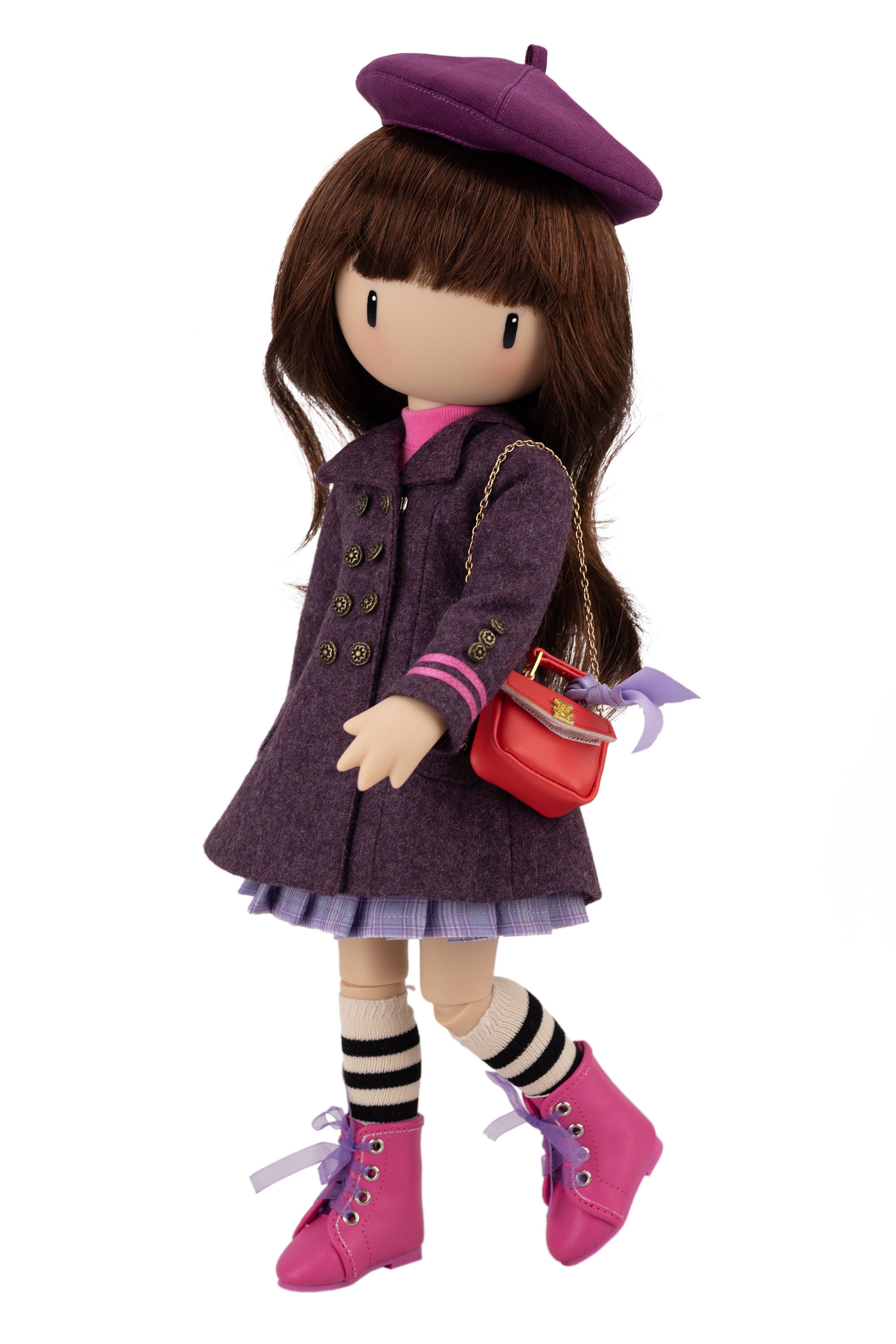 Doll wearing a purple coat, beret, and pink shoes with a red handbag on a white background