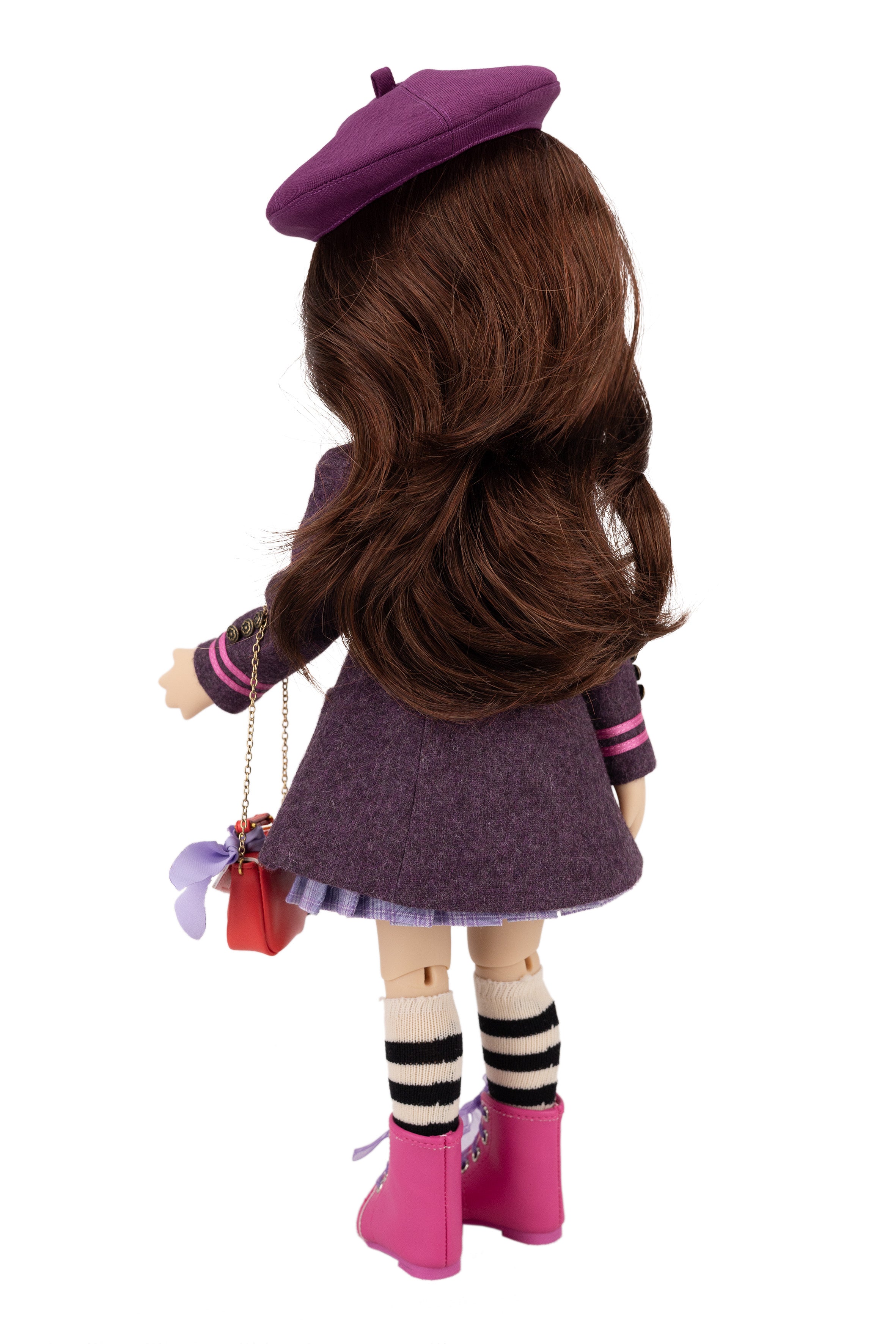 Doll with long brown hair wearing a purple outfit and hat on a white background