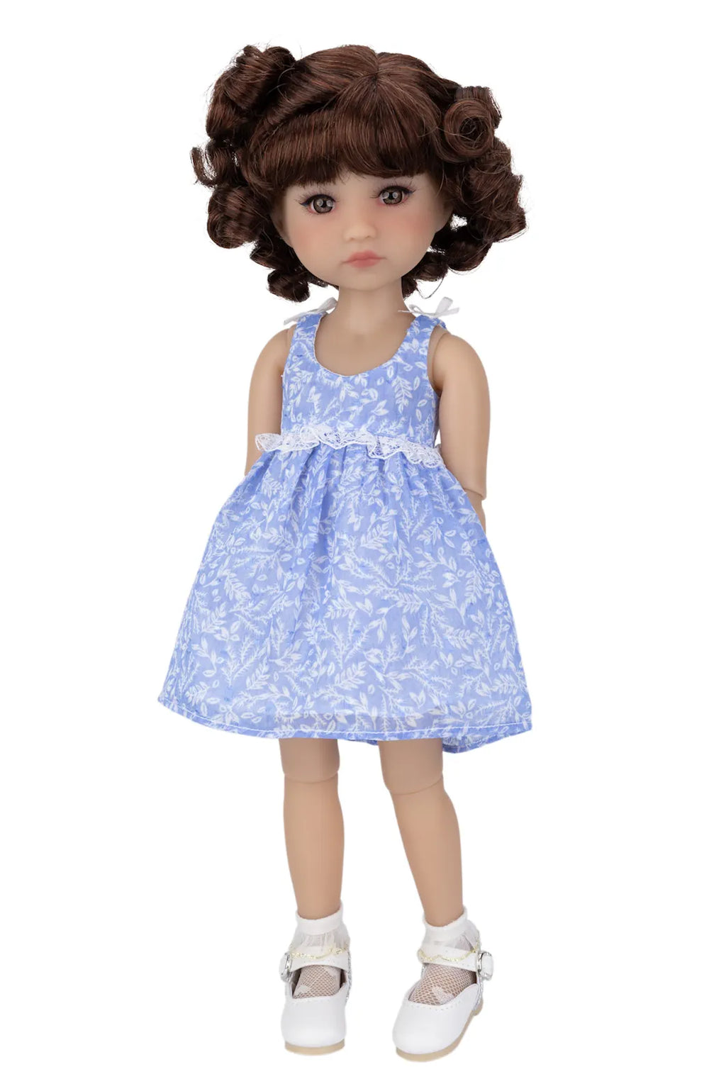 Doll wearing a blue floral dress on a white background