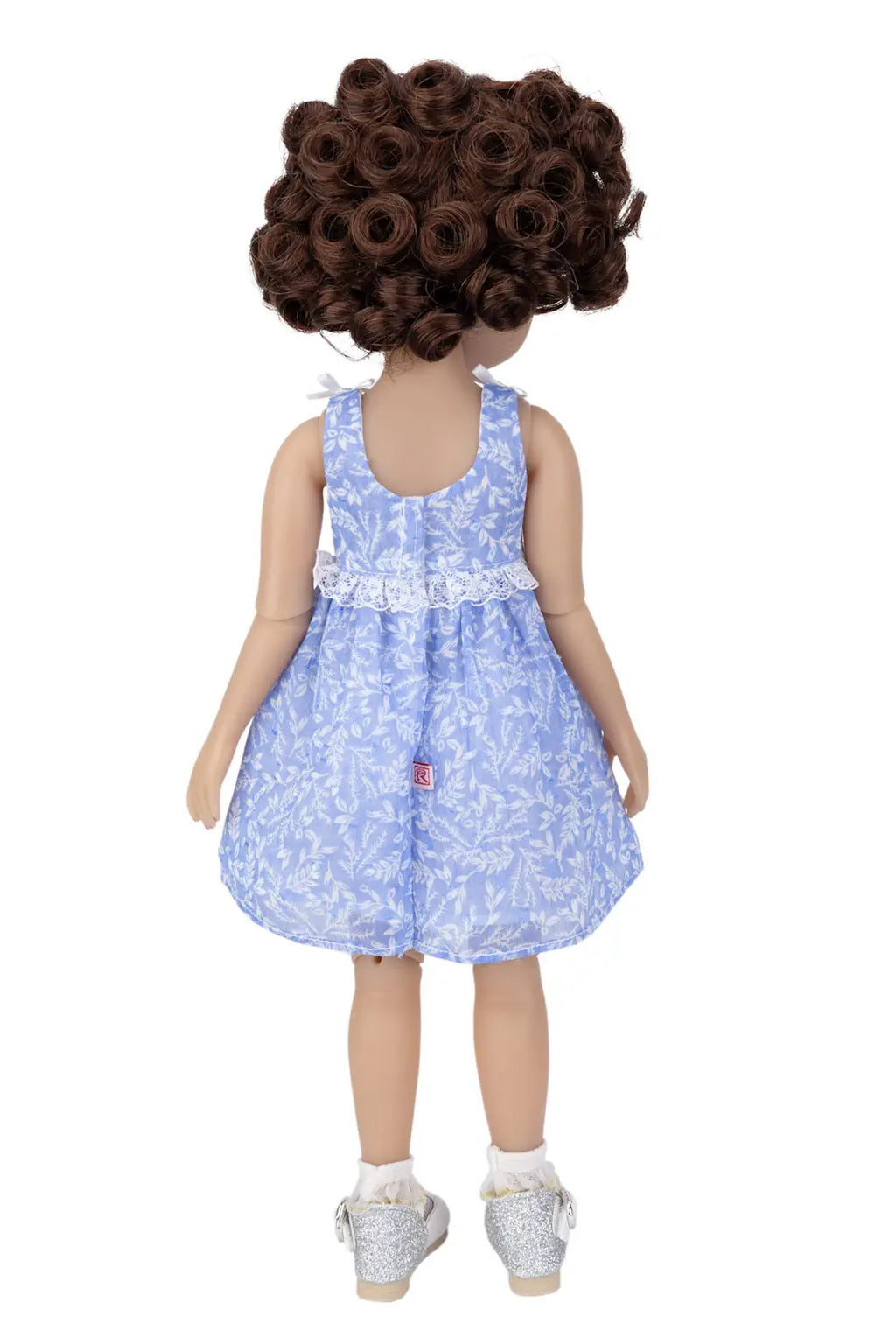 Doll wearing a blue floral dress on a white background