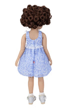 Doll wearing a blue floral dress on a white background