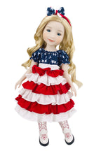 Doll wearing a red, white, and blue dress with a bow on a white background