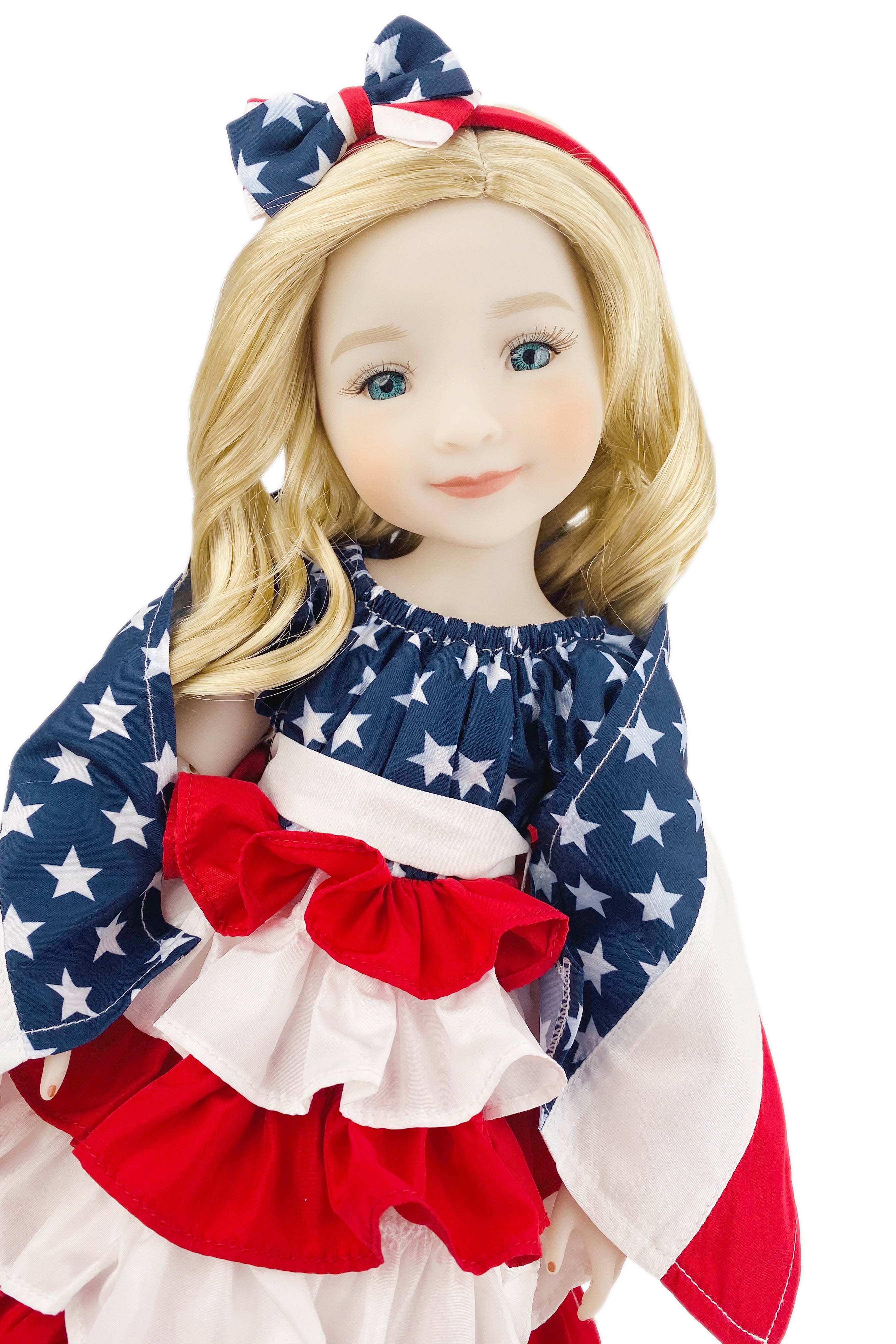 Doll wearing a dress with American flag design on a white background