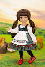 Doll in traditional outfit with a scenic background