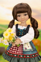 Doll with brown hair styled in pigtails, wearing a traditional outfit with a checkered skirt and holding flowers.