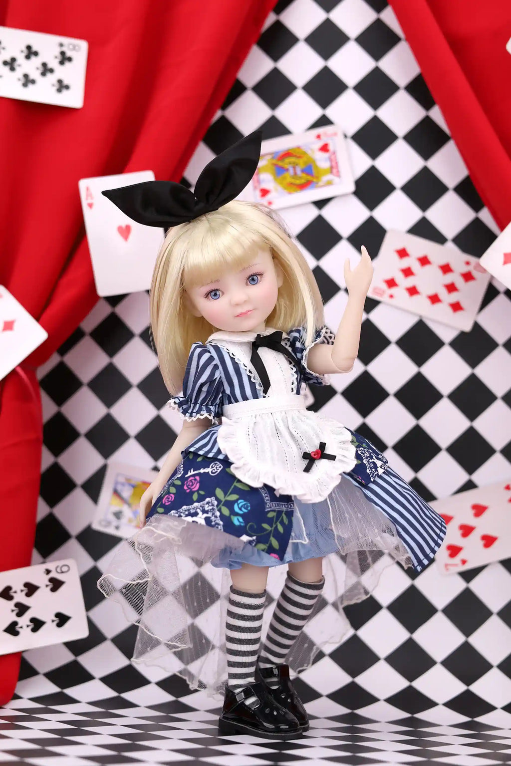 Doll in a costume with playing cards and a checkered background