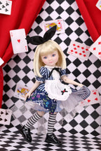 Doll in a blue dress with a black bow on a checkered floor with playing cards