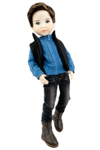 Doll wearing a blue sweater, black vest, jeans, and brown boots on a white background