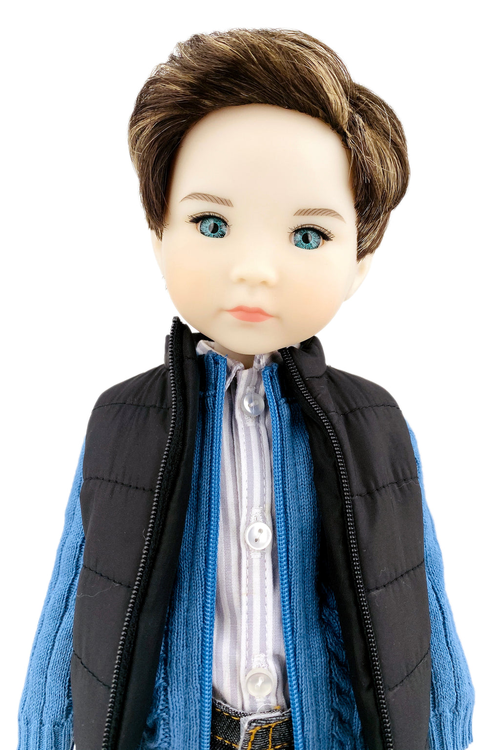 Doll wearing a black vest, blue scarf, and white shirt on a white background