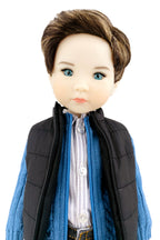 Doll wearing a black vest, blue scarf, and white shirt on a white background