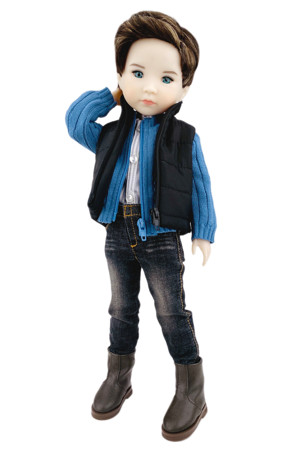Doll wearing a blue jacket, black vest, jeans, and brown boots on a white background