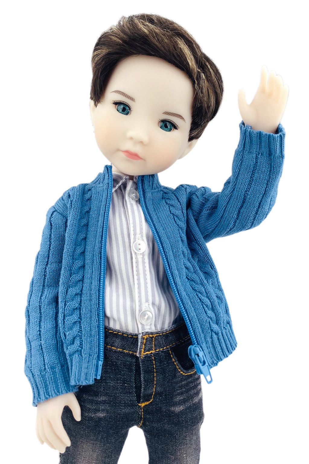 Doll wearing a blue cardigan over a striped shirt on a white background