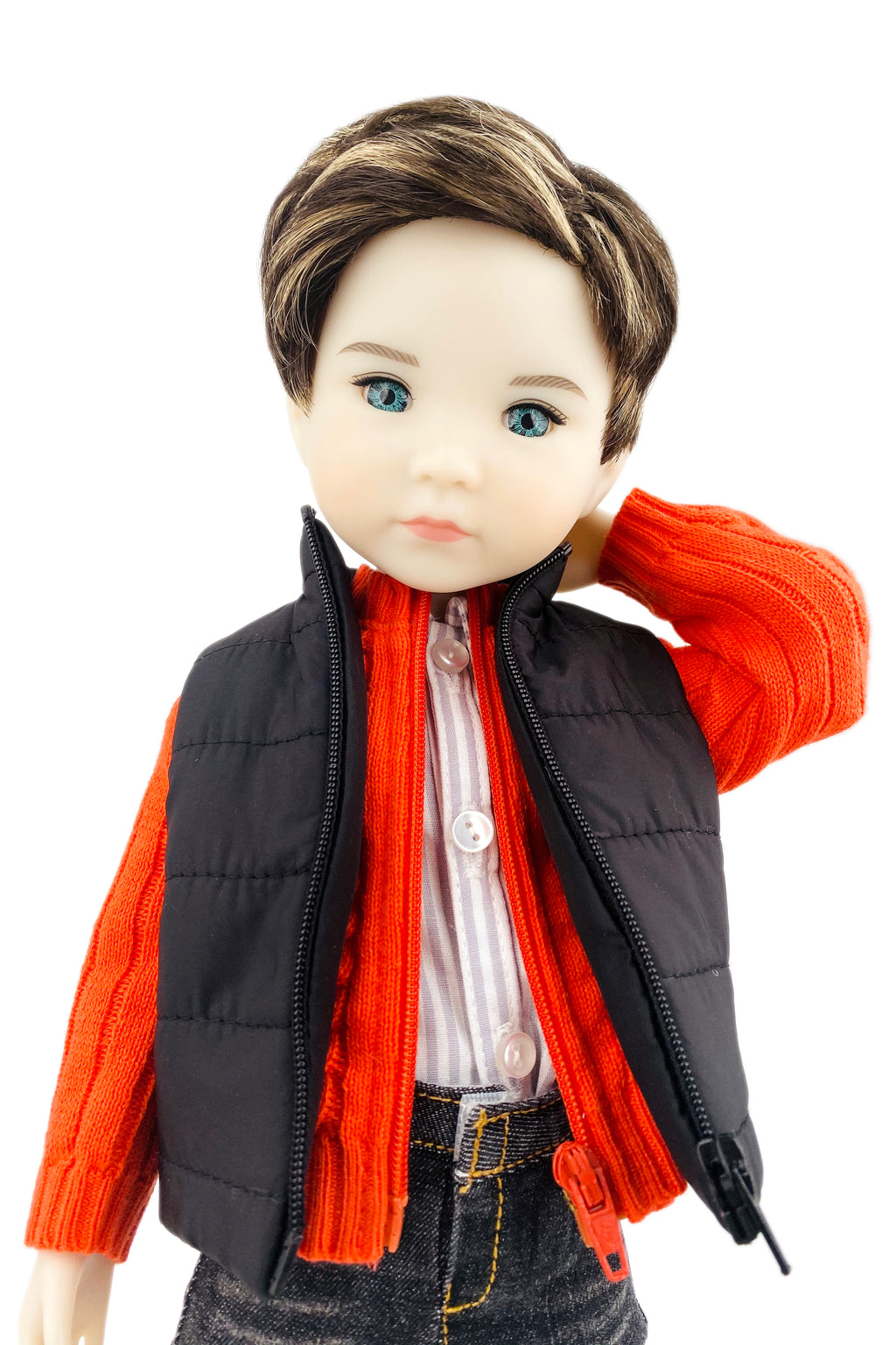 Doll wearing an orange sweater, black vest, and jeans on a white background
