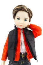 Doll wearing an orange sweater, black vest, and jeans on a white background