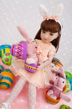 Doll with bunny ears surrounded by Easter-themed plush toys on a light gray background